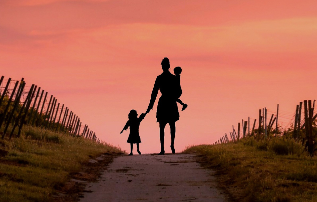 woman walking away holding two small children. Image by Mohamed Hassan from Pixabay.